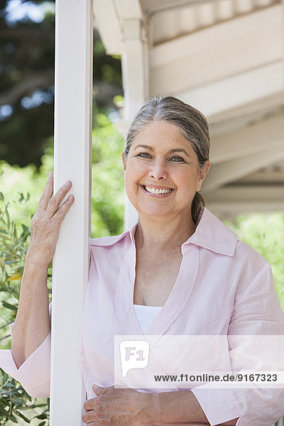 Senior Caucasian woman standing on porch