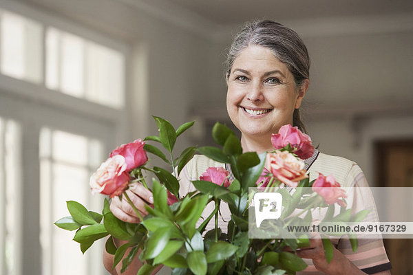 Caucasian woman arranging flowers