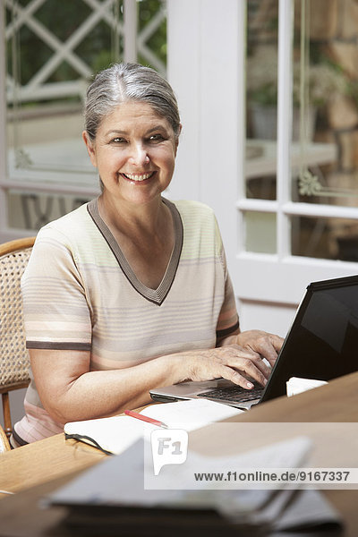 Senior Caucasian woman working on laptop