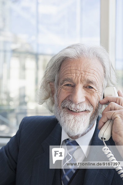 Senior Caucasian businessman talking on phone