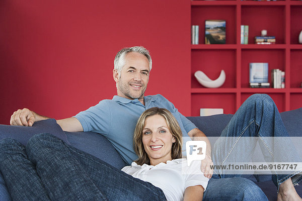 Couple relaxing together in living room