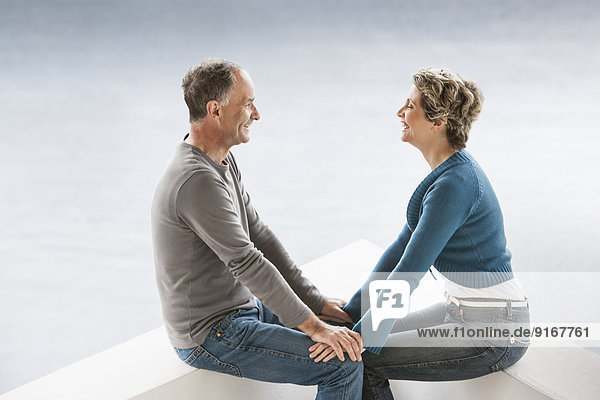 Couple sitting together on benches