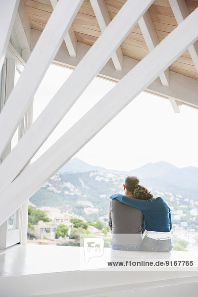 Couple admiring view from balcony