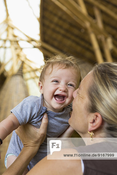 Caucasian mother playing with baby boy