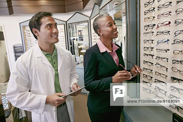 Woman trying on glasses at optometrist