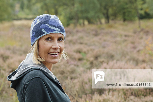 Caucasian woman smiling in rural field