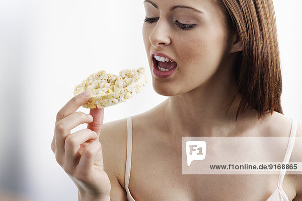 Caucasian woman eating rice cake