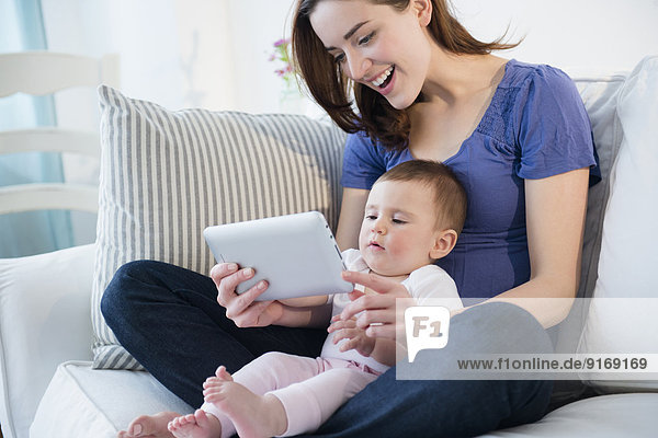 Mother and baby using digital tablet