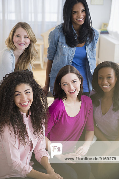 Women smiling together in living room