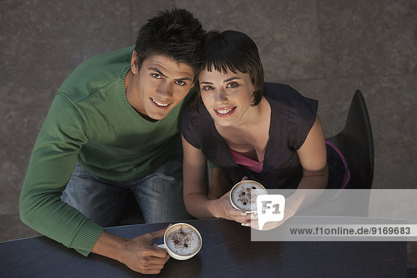 Caucasian couple drinking coffee together