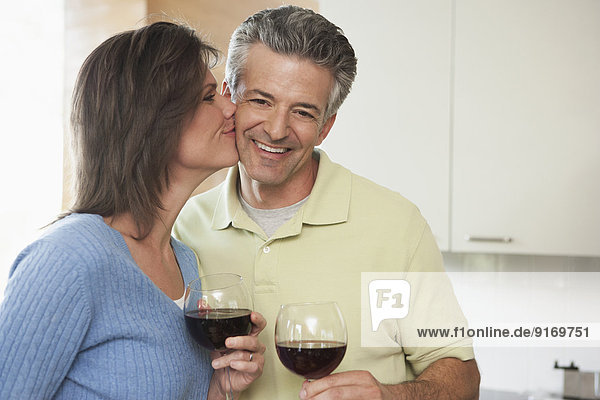 Hispanic couple having wine together