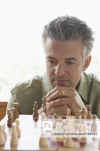 Hispanic man playing chess