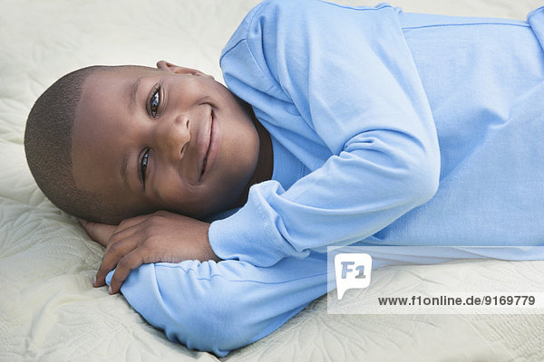 African American boy smiling on picnic blanket