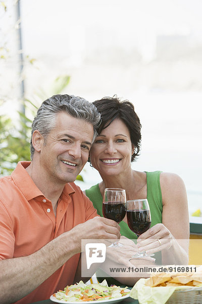 Senior Caucasian couple toasting each other with wine