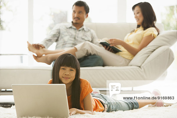 Girl using laptop in living room