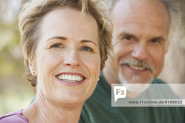 Senior Caucasian couple smiling outdoors