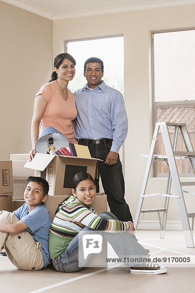 Hispanic family smiling in new home