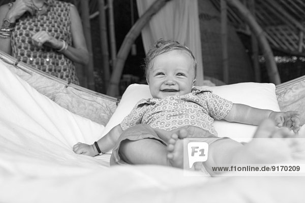 Caucasian baby smiling in crib