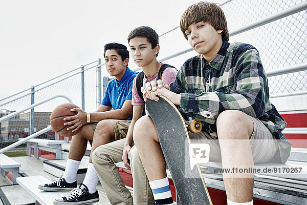 Teenage boys sitting on bleachers