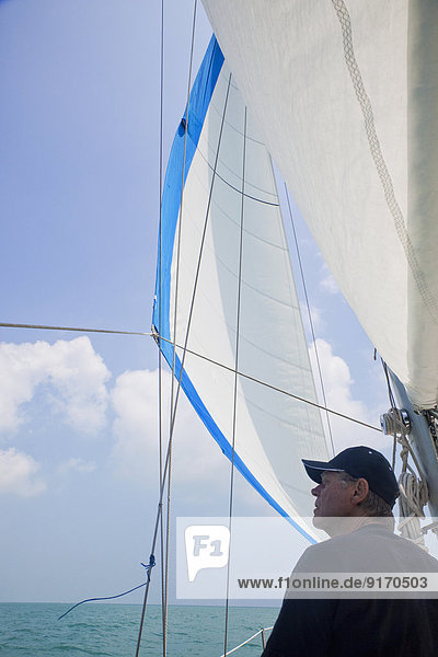 Senior Caucasian man standing on sailboat