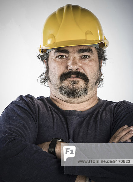 Construction worker standing with arms crossed