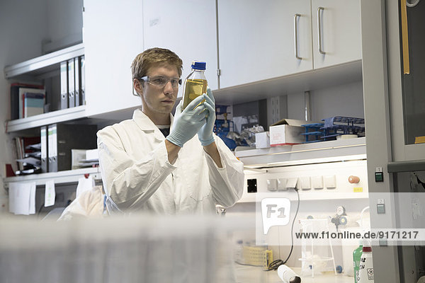 Scientist in a biological lab analyzing liquid