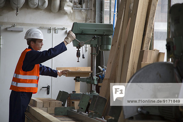 Young worker at carpentry of pallet production