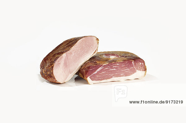Gammon and cooked ham in front of white background