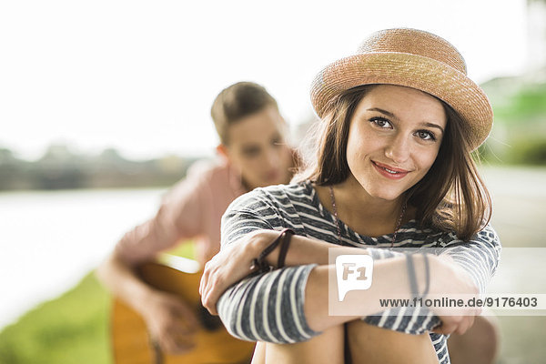 Portrait of happy teenage girl wearing summer hat