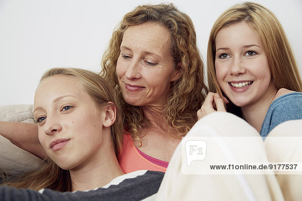 Portrait of mother and her two daughters at home