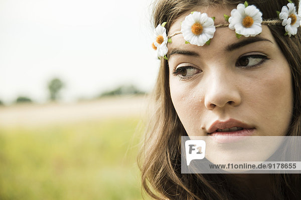 Portrait of young woman wearing floral wreath