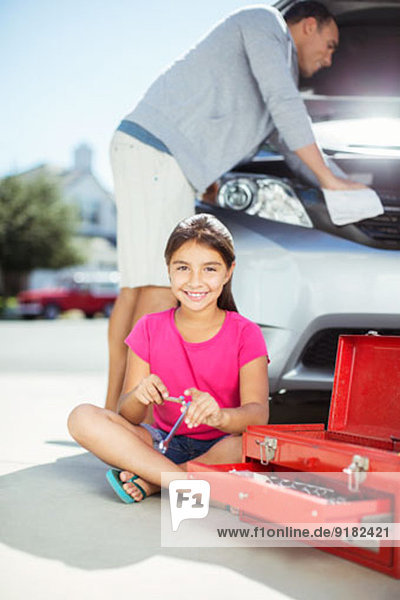 Vater und Tochter reparieren Automotor in der Einfahrt