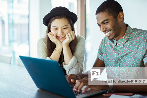 People working together on laptop in office