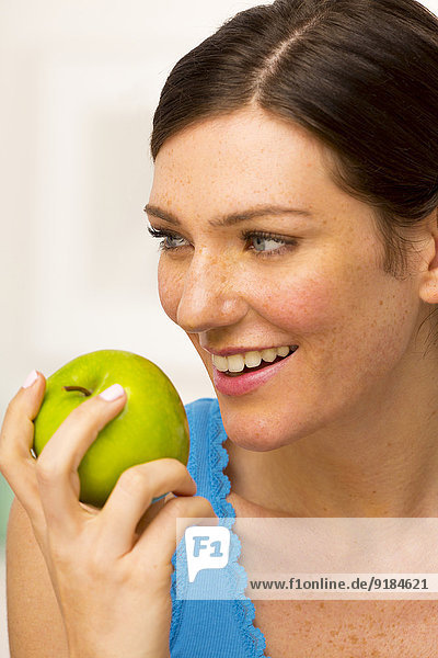 Caucasian woman eating apple