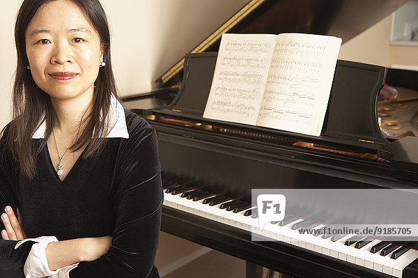 Chinese woman sitting at piano