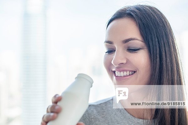 Close up of young woman drinking milk