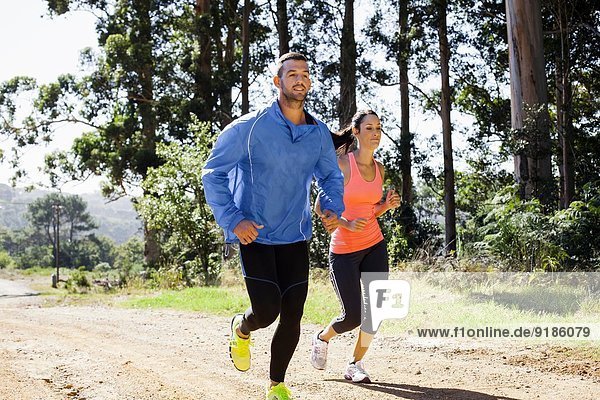 Young couple jogging in forest