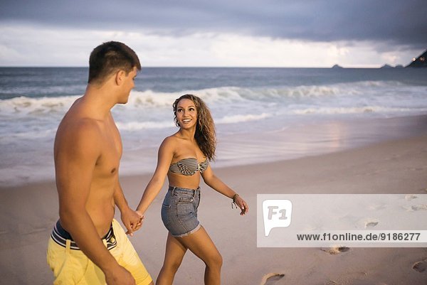 Romantic young couple strolling on Ipanema Beach  Rio de Janeiro  Brazil