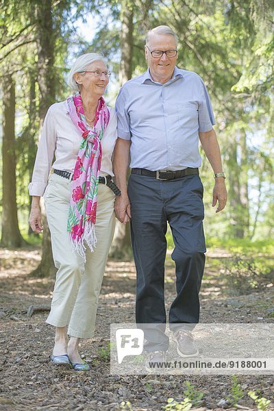 Senior couple walking in forest