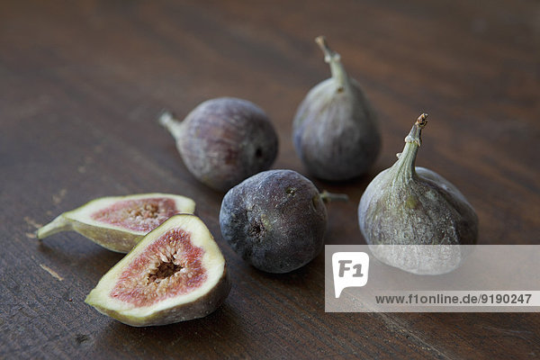 Close-up of figs on wooden table