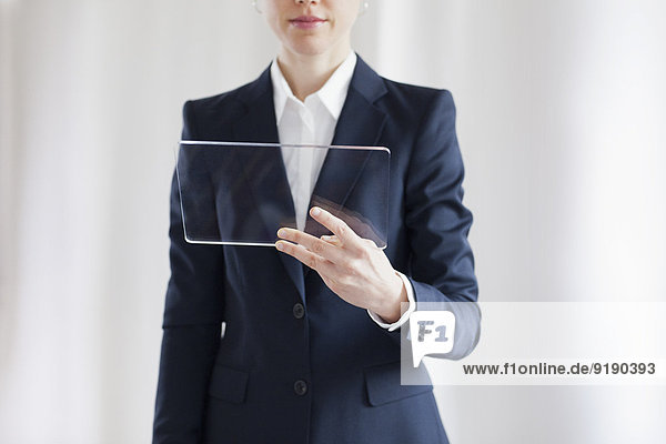 Close-up Of Businesswoman Holding Blank Glass Digital Tablet