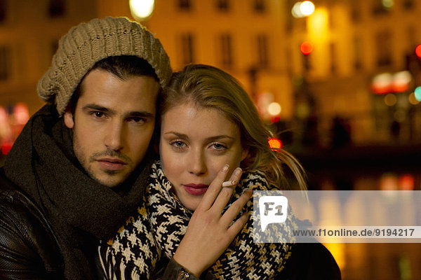 Young couple out in the city at night  portrait