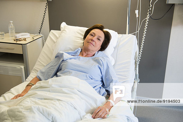 Woman lying in hospital bed