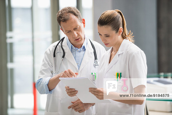 Two doctors discussing medical report in hospital