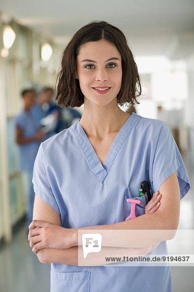 Portrait of a female nurse standing with her arms crossed
