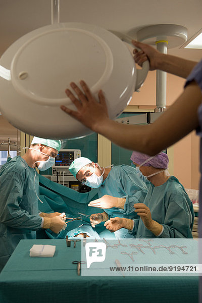 Medical team operating a patient in an operating room