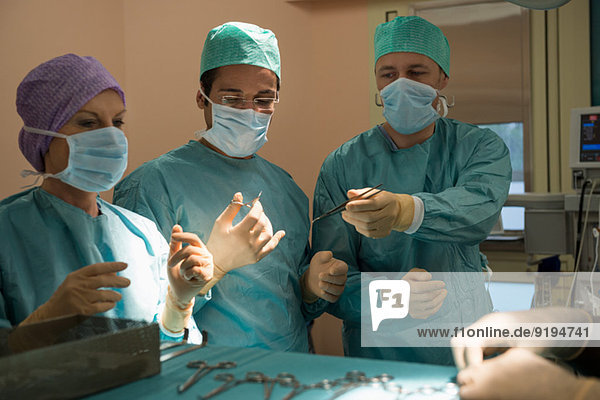 Surgeons operating a patient in an operating room