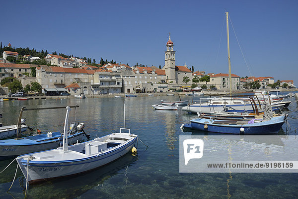 Fishing boats in the harbour in front of the church of Sveti Ivan  St Ivan  Sutivan  Island of Bra?  Dalmatia  Croatia