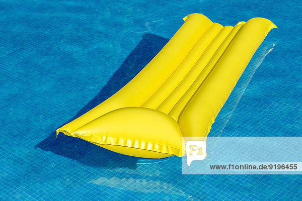 Yellow lilo in a swimming pool
