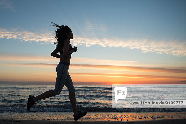 Young Girl Running On The Beach
